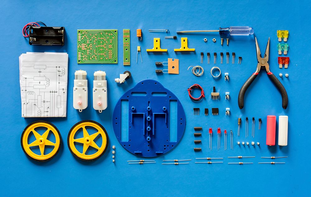 Electronics tools equipments flat lay on blue background