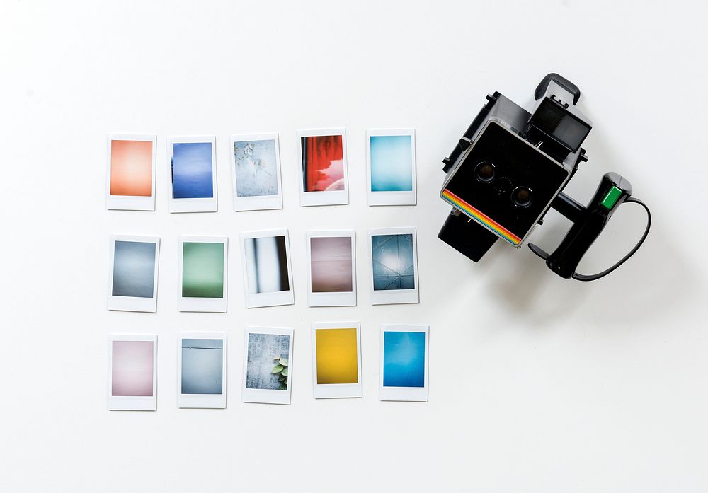 Instant camera and photos isolated on background