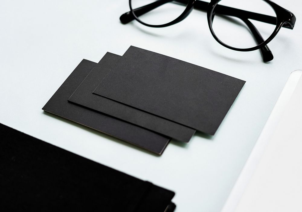 Black paper cards with eyeglasses on table