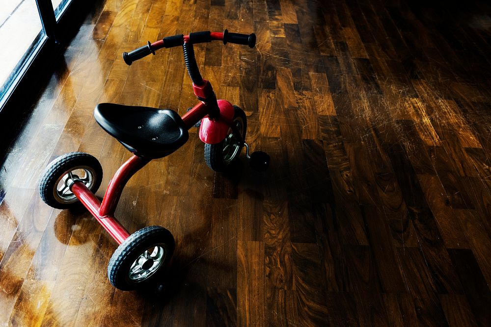 Kid bicycle on the wooden floor