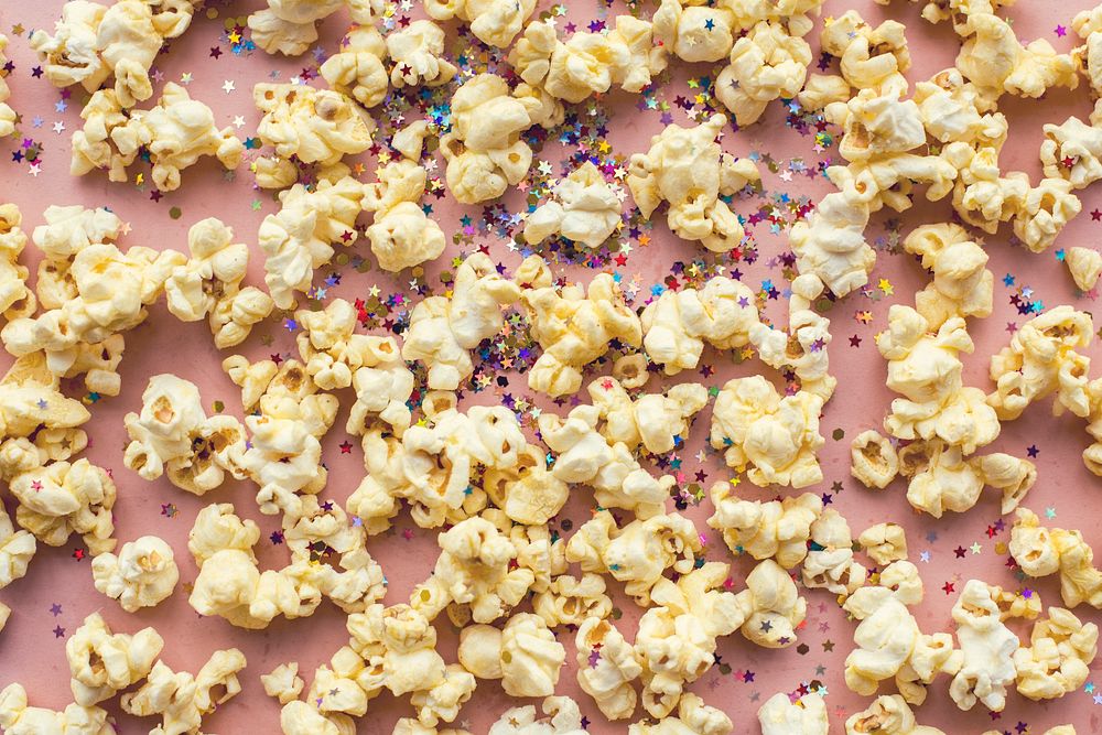 Popcorn and confetti isolated on background