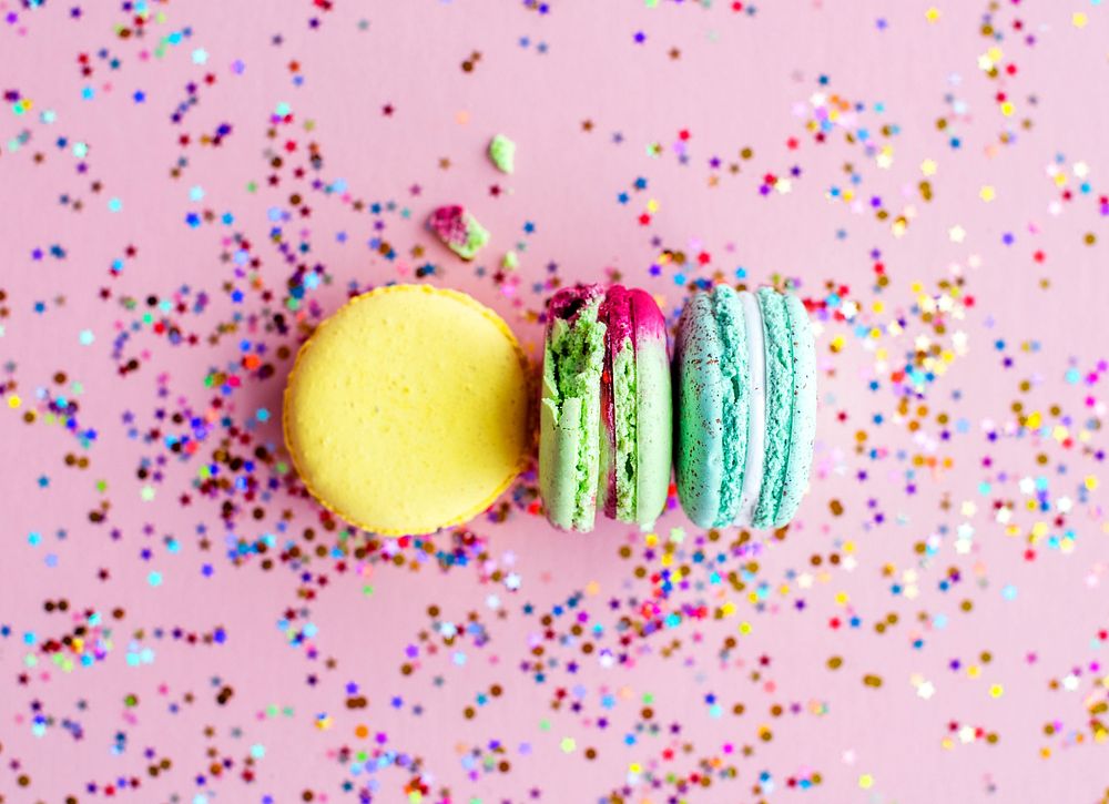 Macaron with confetti and pink background