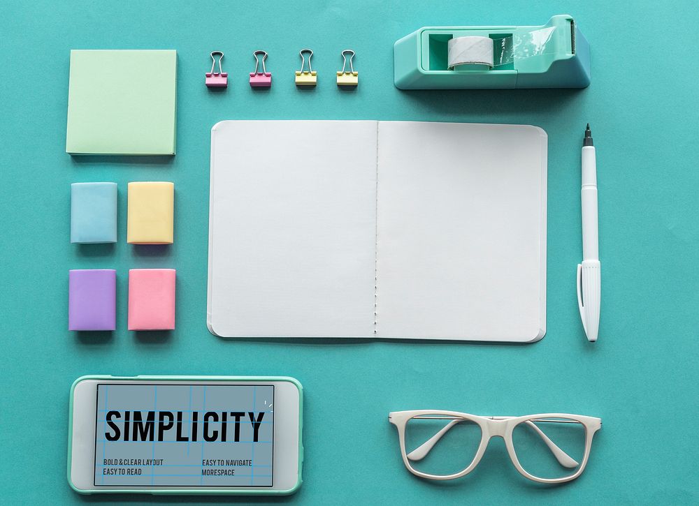 Simplicity word on smart-phone screen and office supplies