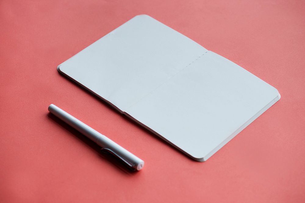 Blank notebookand pen isolated on background