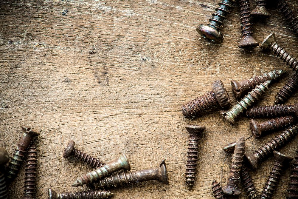 Aerial view of rustic screws on wooden plank macro