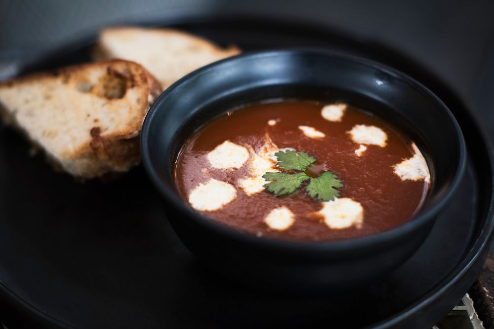 Warm tomato soup bowl and bread