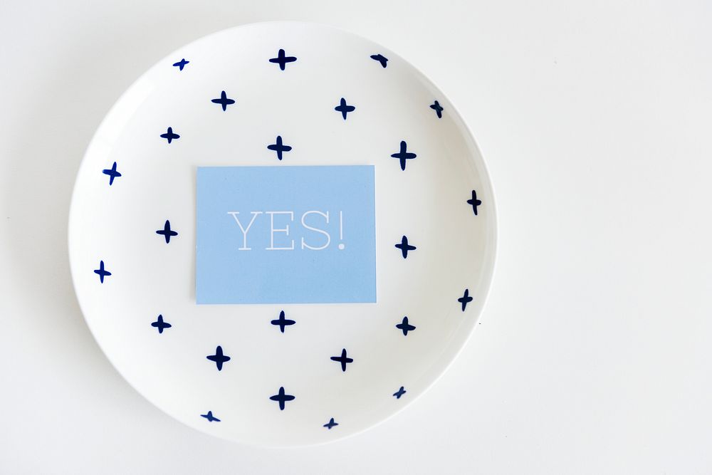 Yes word note on ceramic plate on white background