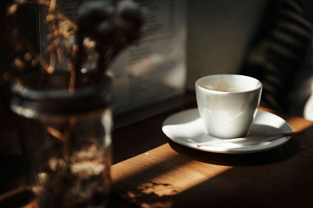 Closeup of white coffee cup on wooden table