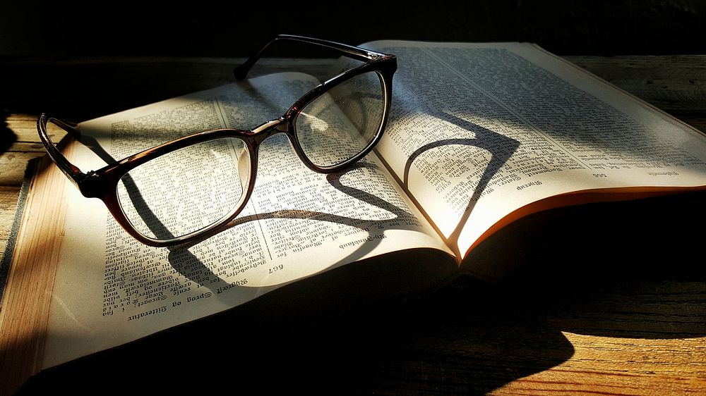 A pair of glasses and a book