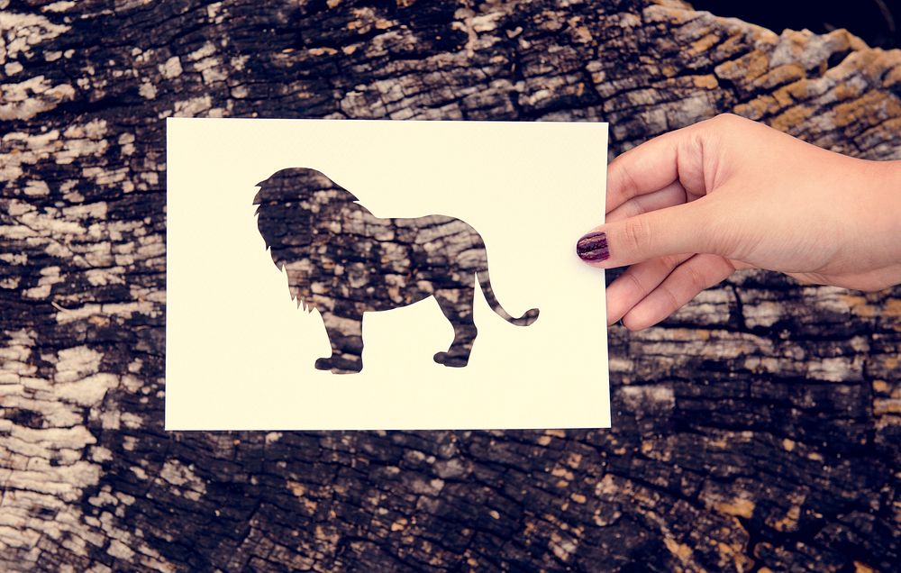 Hand Hold Lion Paper Carving with Wooden Background