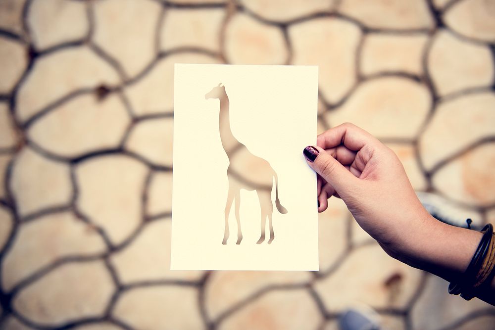 Hand Hold Giraffe Paper Carving with Cracked Background