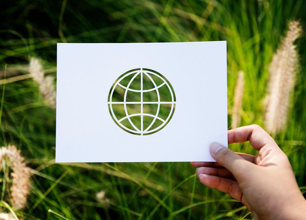 Hand Hold Globe Paper Carving with Grass Background