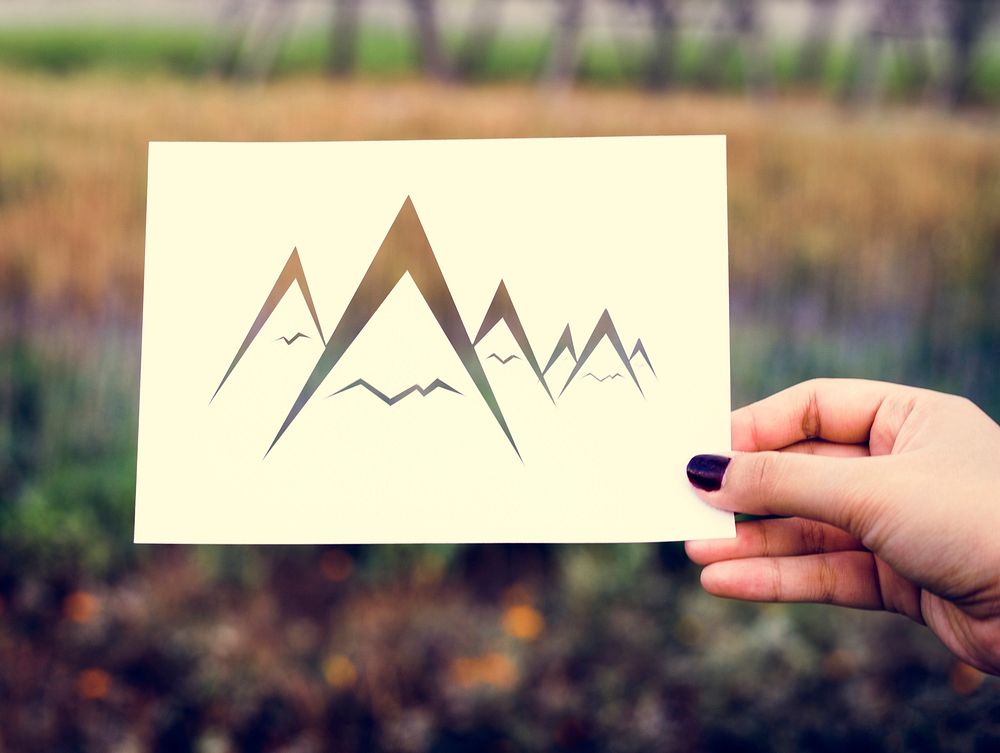 Hand Hold Mountains Paper Carving with Nature Background