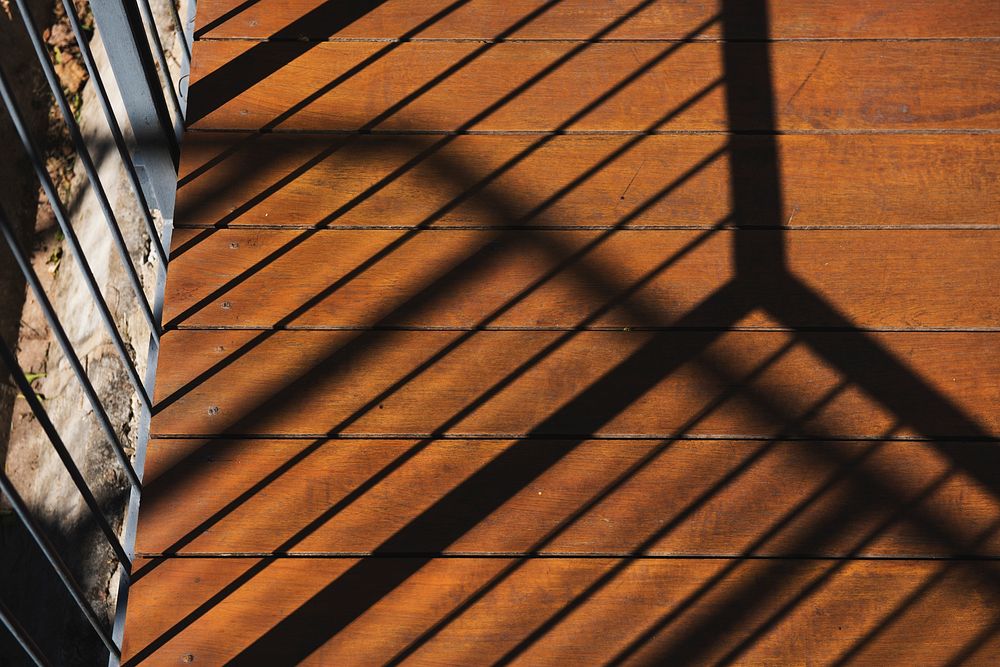 Photo of sunshine to the balcony and reflection the shadow on wooden floor
