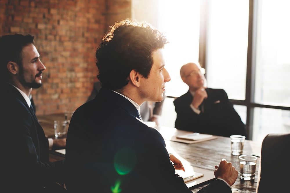 Man listening at a business meeting