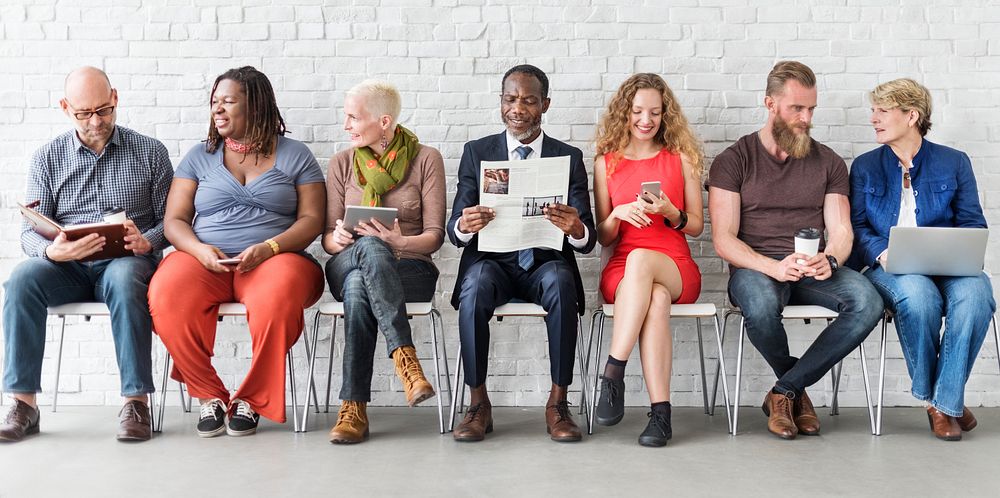 Diverse Group of People Community Togetherness Technology Sitting Concept