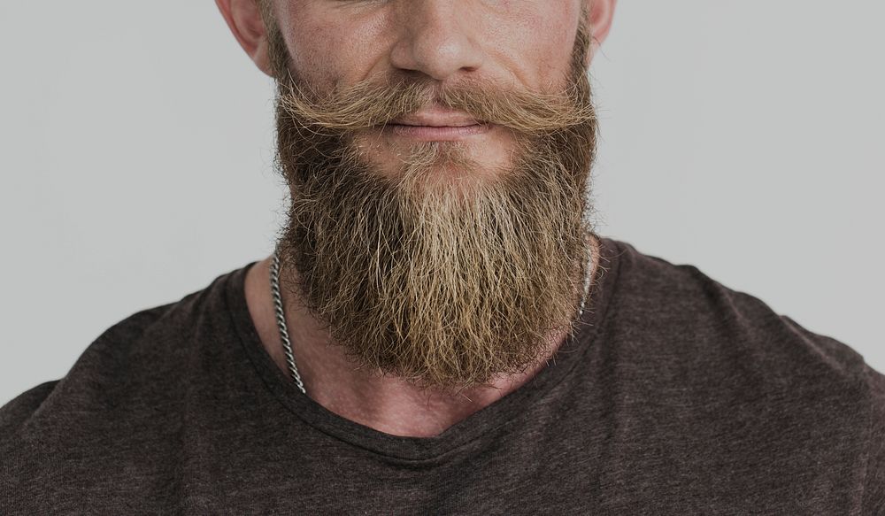 Cropped close up portrait of a bearded guy in a shirt