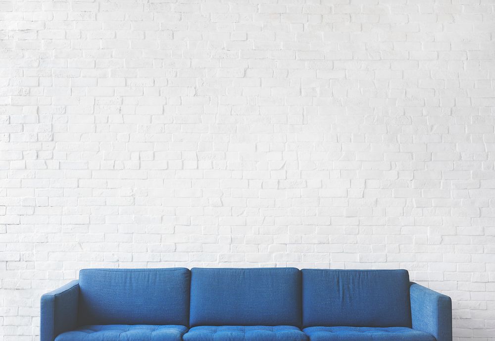 Blue sofa with white brick wall background