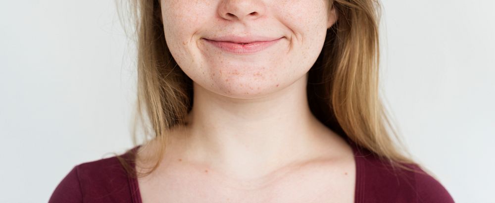 Young girl shy smile studio portrait