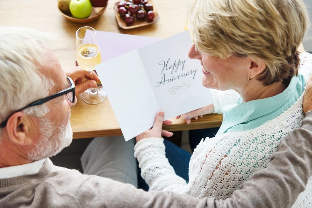 Senior Adult Holding Happy Anniversary Card Concept