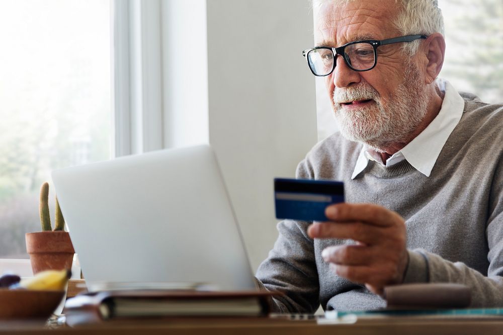 Senior Adult Holding Credit Card Concept