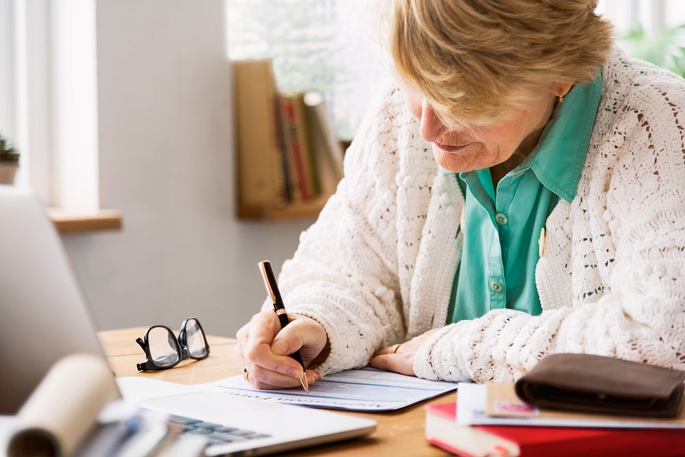 Senior Woman Filling Application Form Documents Concept