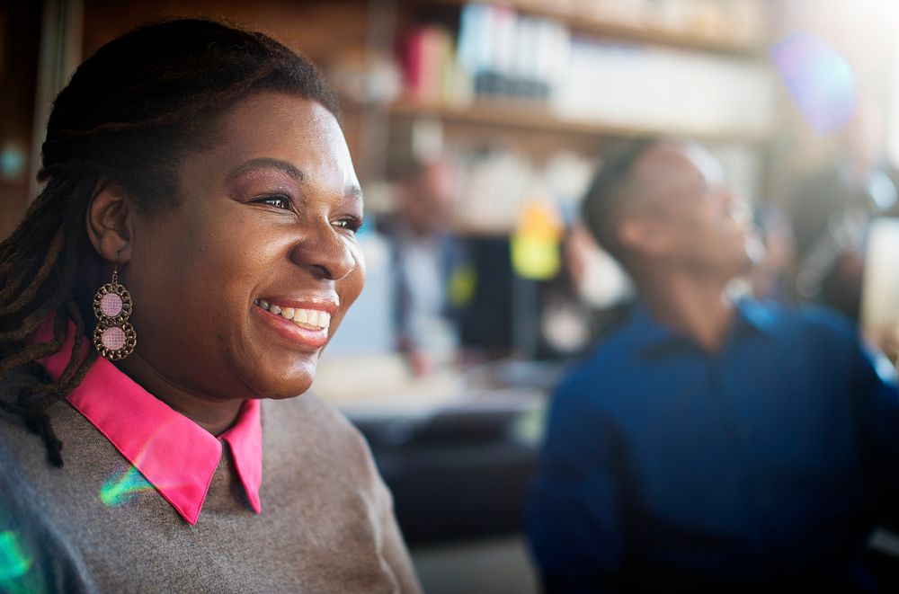Closeup of black woman smiling cheerful at workplace