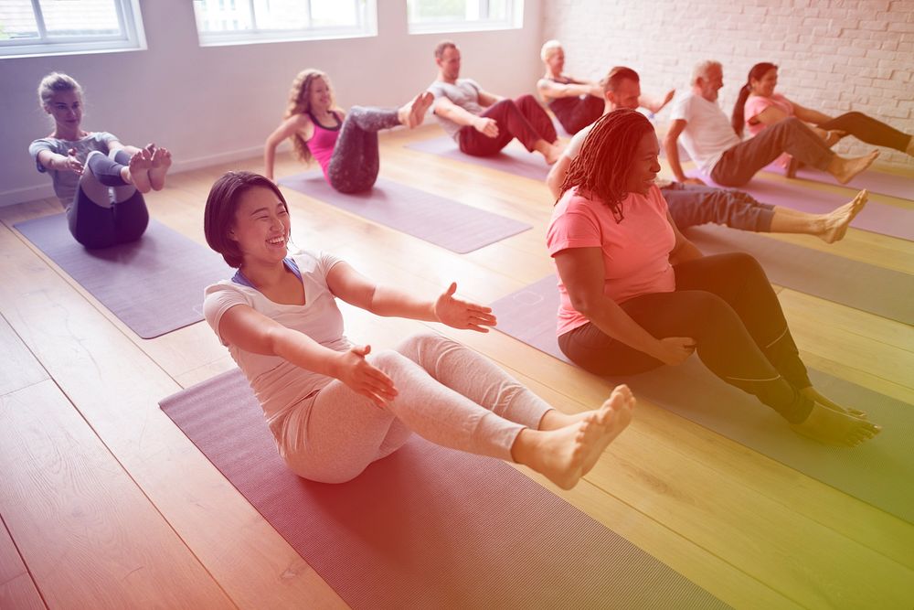Diverse people in a yoga class doing balancing position