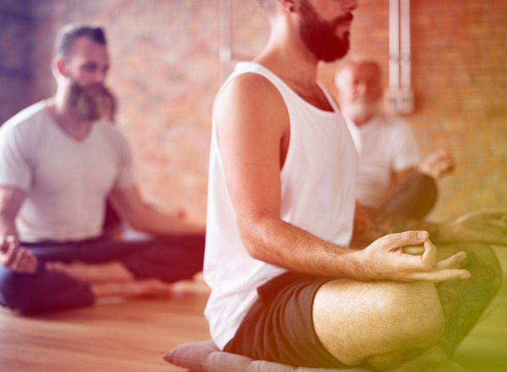 Men meditating gesture in a yoga class