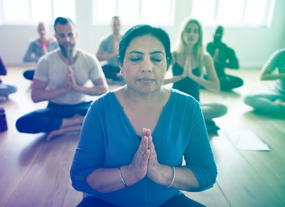 People concentrating to meditate while sitting