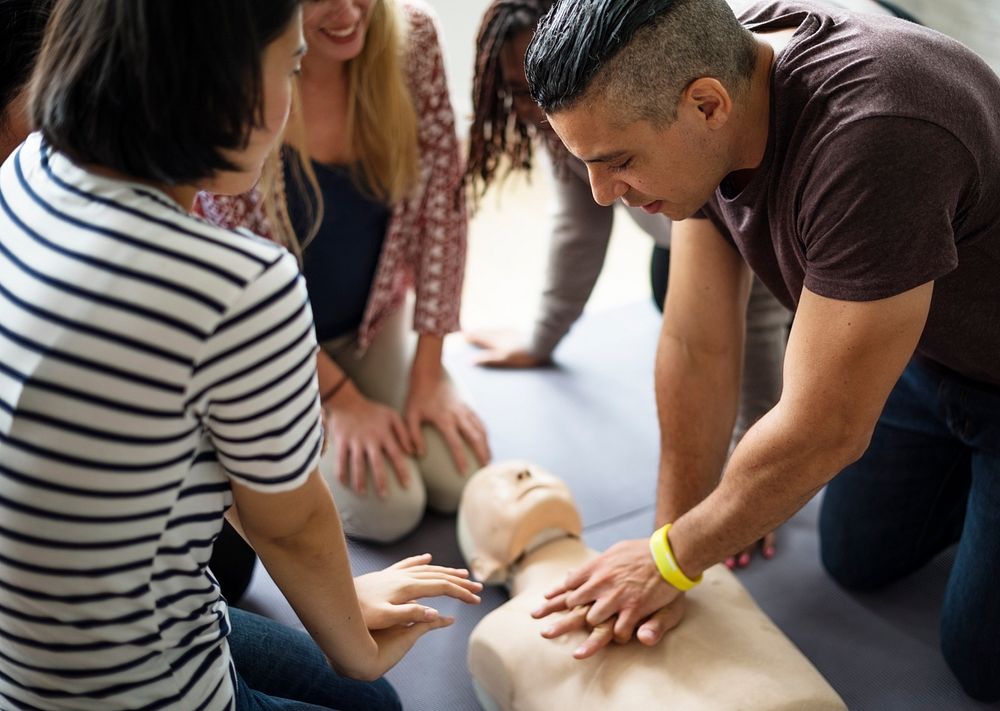 Diverse people taking a CPR first aid training class
