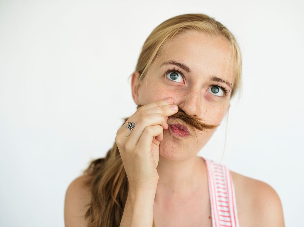 Young girl pretending to have a mustache