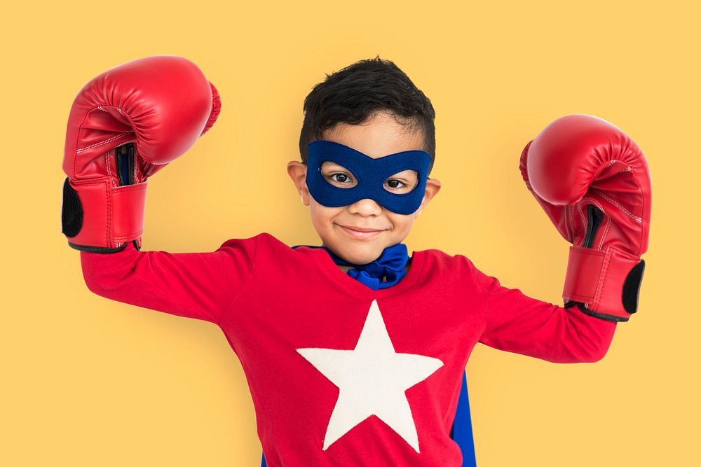 Superhero boy wearing boxing gloves