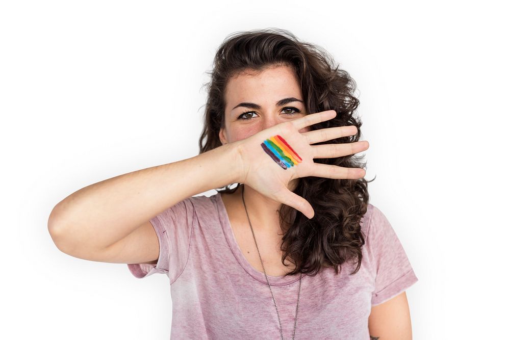 Portrait of a woman showing a pride flag on her palm