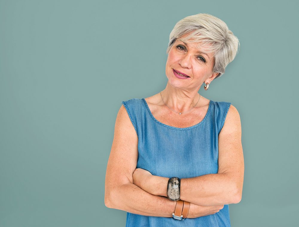 White haired lady with her arms around her body