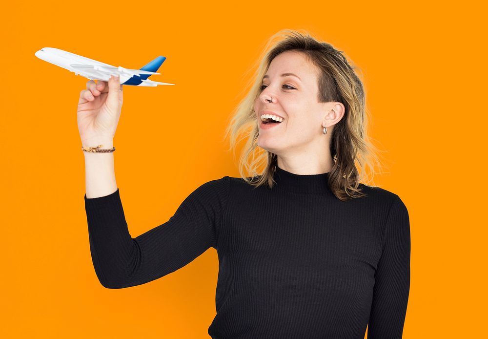 Blonde woman holding a flying plane