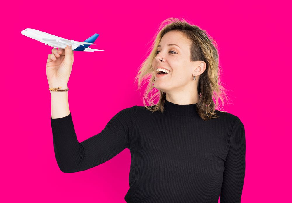 Blonde woman holding a flying plane