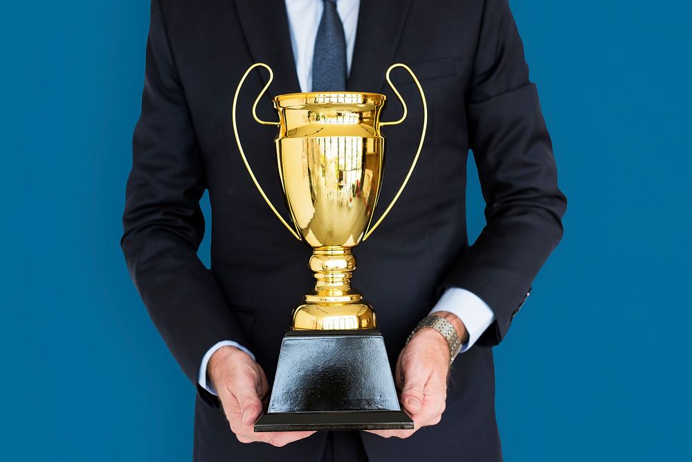 Business Man Holding Trophy