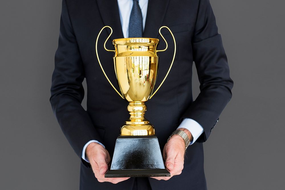 Business Man Holding Trophy