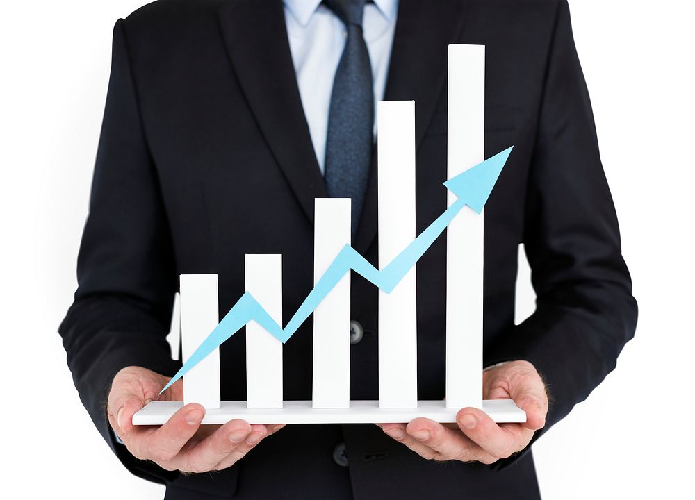 Businessman holding an upward bar graph
