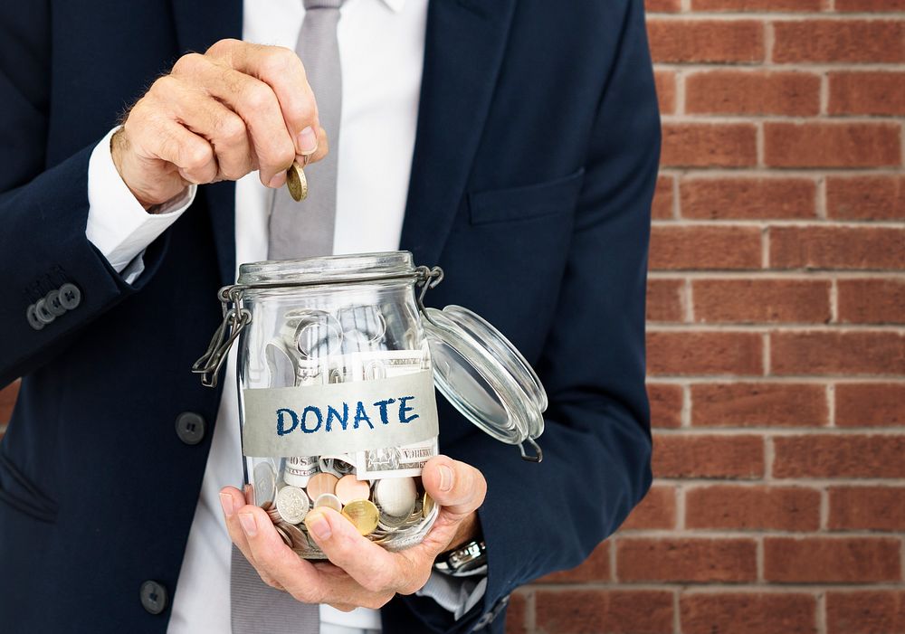 Businessman GIving Money Donation Charity Concept