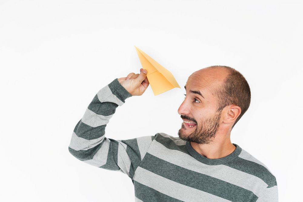 Mature guy flying a paper plane