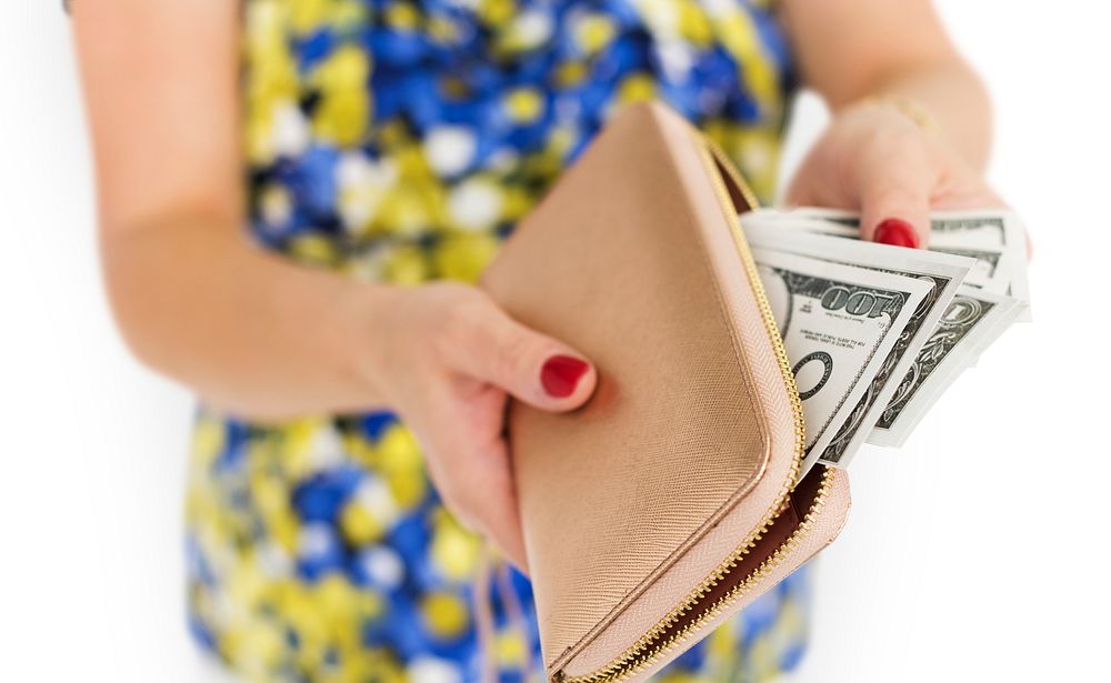 Close up of woman's hands taking money out of the purse