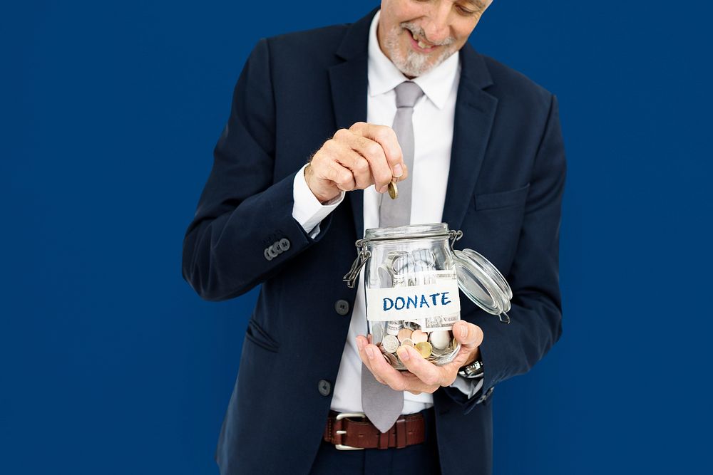 Businessman donating in a jar