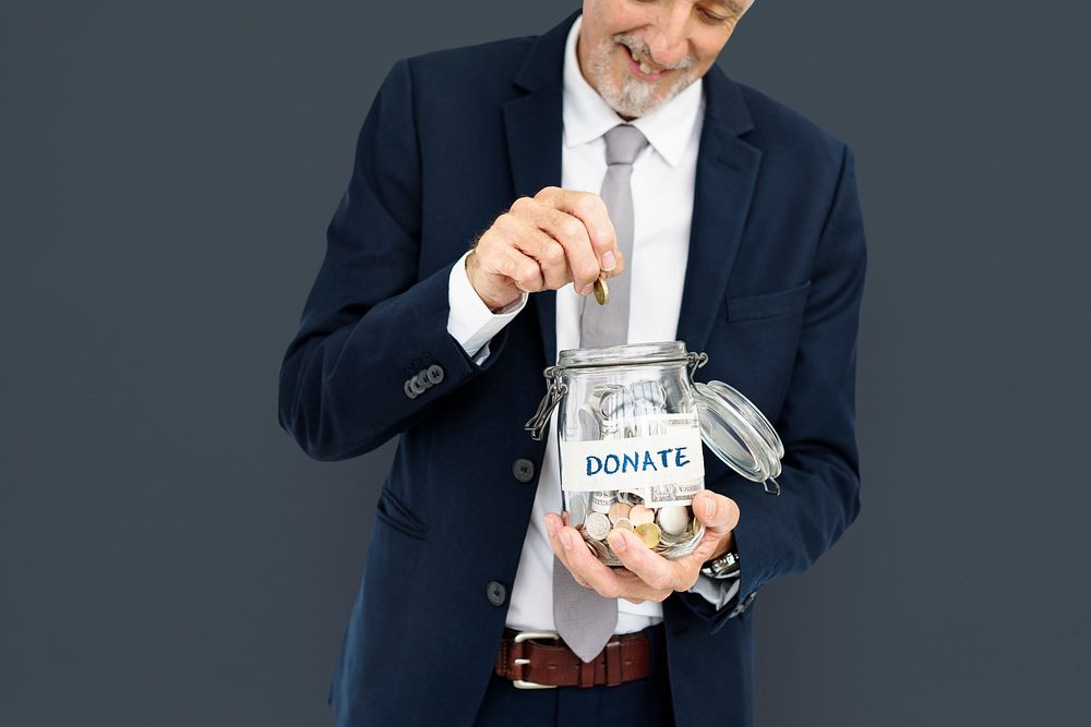 Businessman donating in a jar