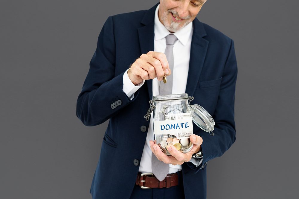 Businessman donating in a jar