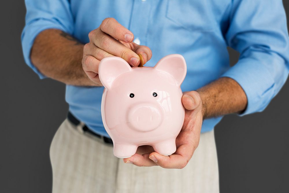 Man Holding Piggy Bank Saving Portrait Concept
