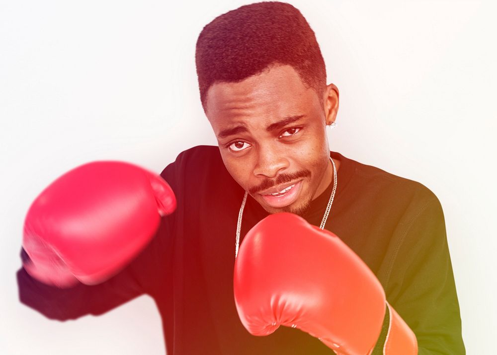 Man With Boxing Glove Punching Studio Portrait