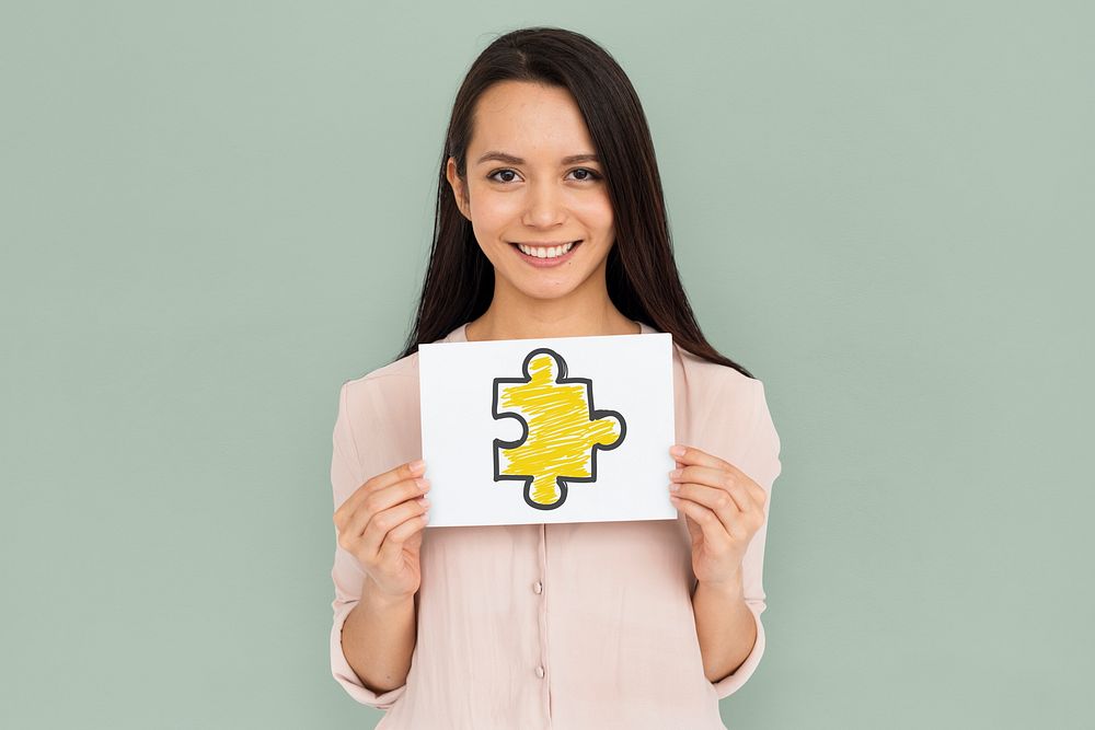 Woman holding placard with jigsaw piece icon