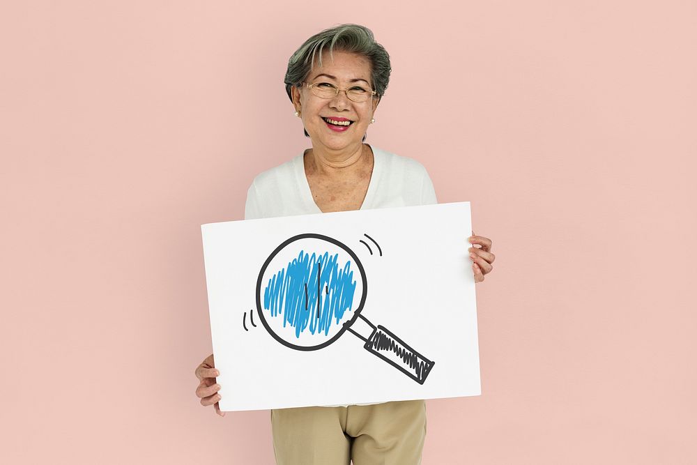 Senior woman holding placard with magnifying glass icon